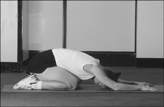 L'enfant's pose in yoga. [Credit: Photograph by Sunstreak Productions, Inc.]